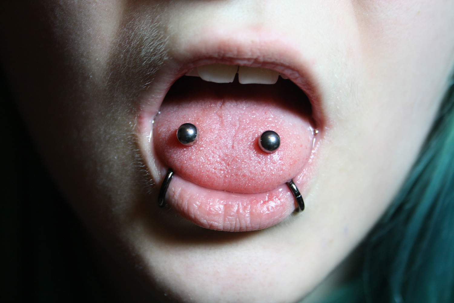 Lower Lips Piercing And Venom Piercing With Silver Studs