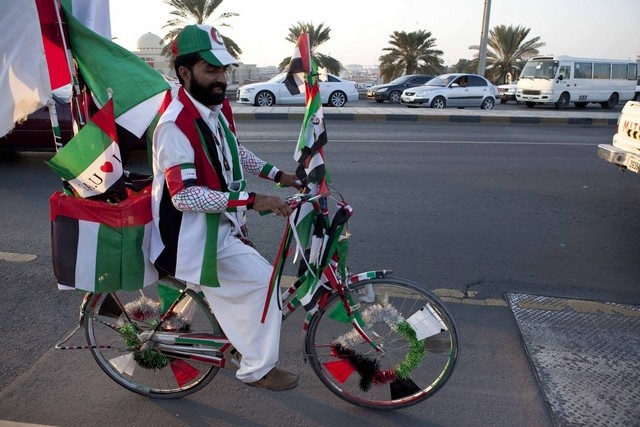 Man Selling UAE Flags During National Day Celebration
