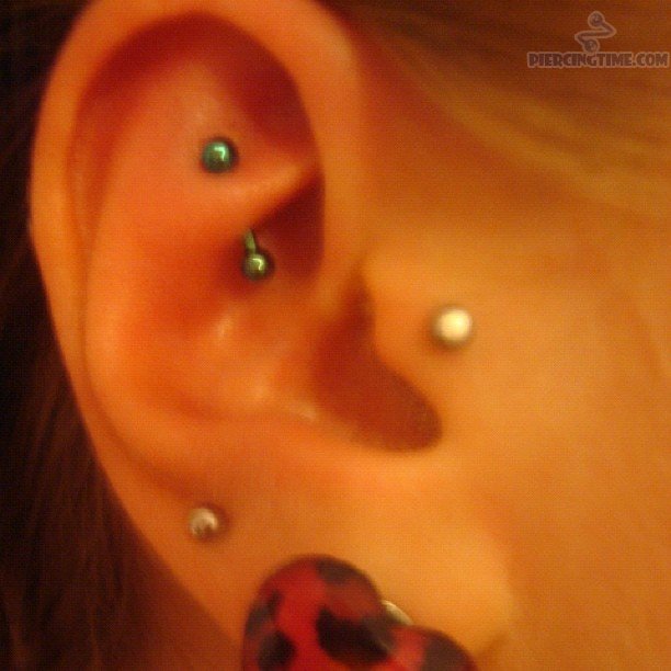 Nice Double Lobe And Tragus Rook Piercing On Girl Right Ear