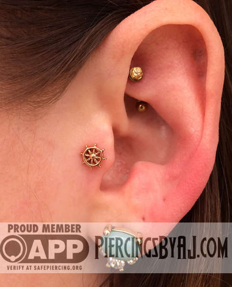 Nice Tragus And Rook Piercing With Gold Barbell