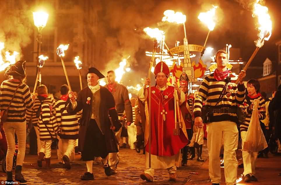 Participants In The Guy Fawkes Night Parade Holding Flaming Torches
