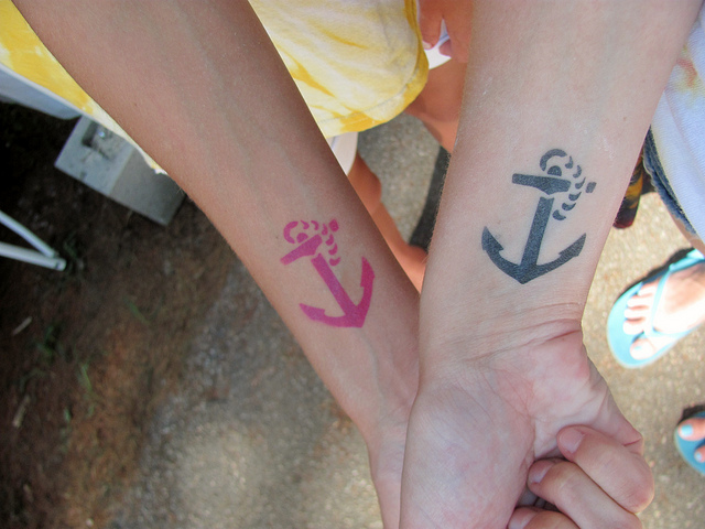 Pink And Black Anchor Tattoo On Couple Wrist