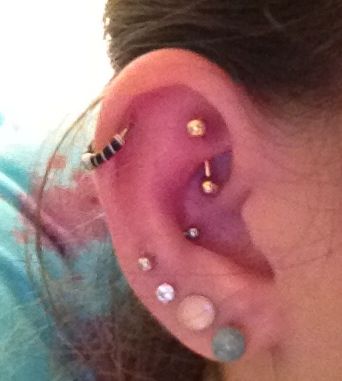 Right Ear Lobe Piercing With Snug And Rook Piercing