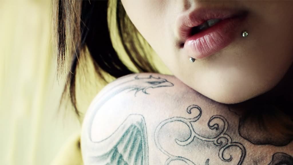 Shoulder Tattoo And Body Piercing With Silver Barbell