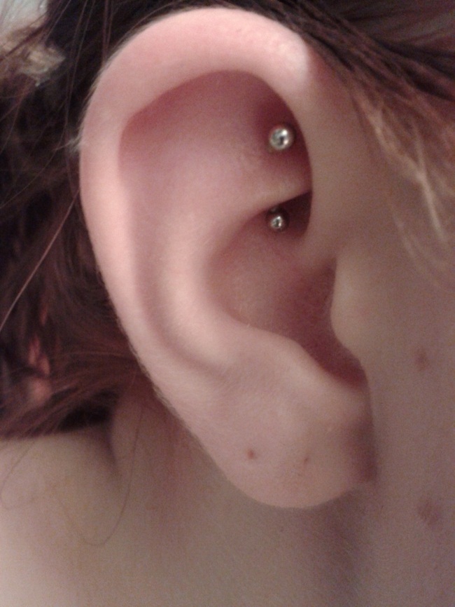 Silver Barbell Rook Piercing On Girl Right Ear