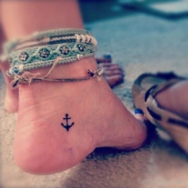 Simple Black Anchor Tattoo On Girl Left Heel