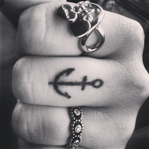 Simple Black Ink Anchor Tattoo On Finger