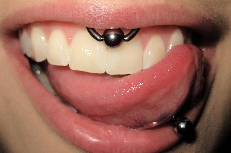 Tongue And Smiley Piercing With Bead Ring