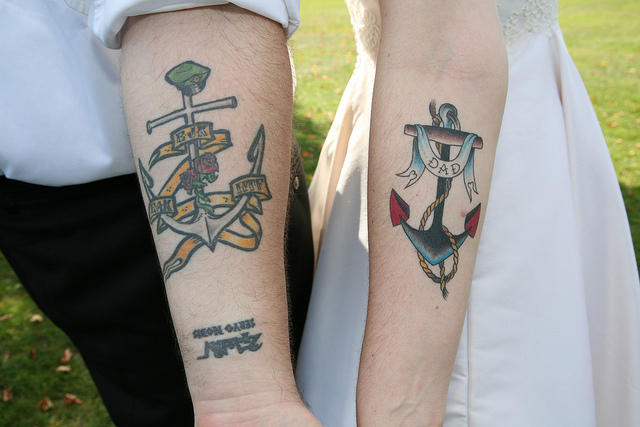 Traditional Anchor With Banner Tattoo On Couple Forearm.