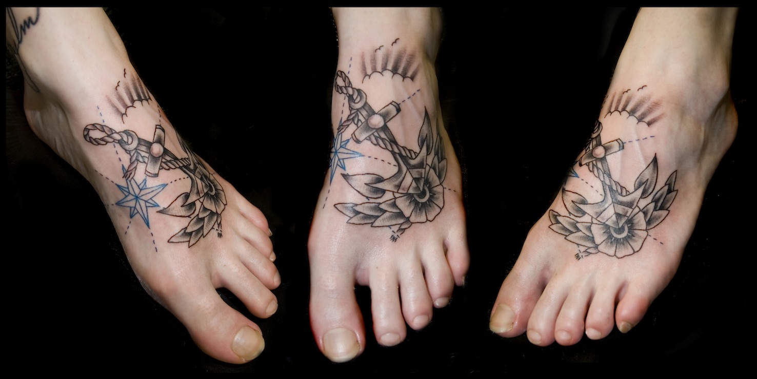 Traditional Black Ink Anchor With Rope And Flower Tattoo On Left Foot