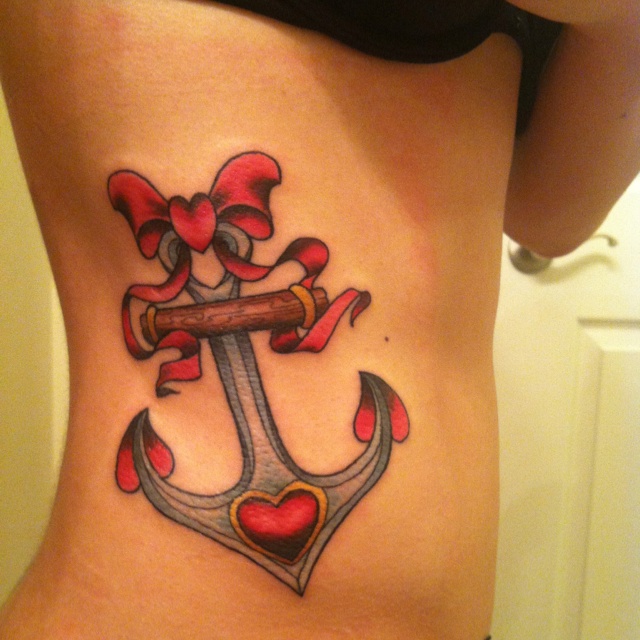 Traditional Colorful Anchor With Bow Tattoo On Girl Right Side Rib