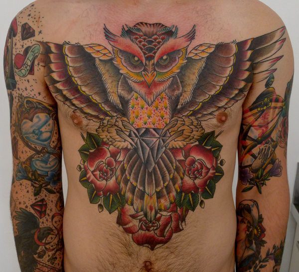 Traditional Owl With Hourglass And Flowers Tattoo On Man Chest