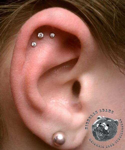 Triple Cartilage Piercing On Girl Right Ear