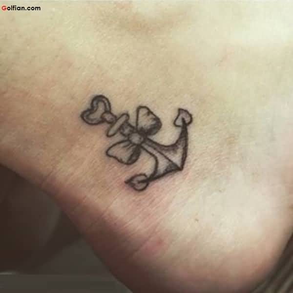 Wonderful Black Ink Anchor With Bow Tattoo On Left Ankle
