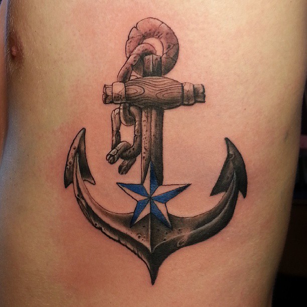 Wonderful Black Ink Anchor With Nautical Star Tattoo On Man Left Side Rib