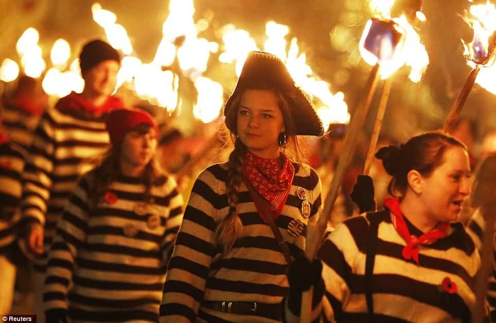 Young Participants Holding Burning Torches During Guy Fawkes Parade