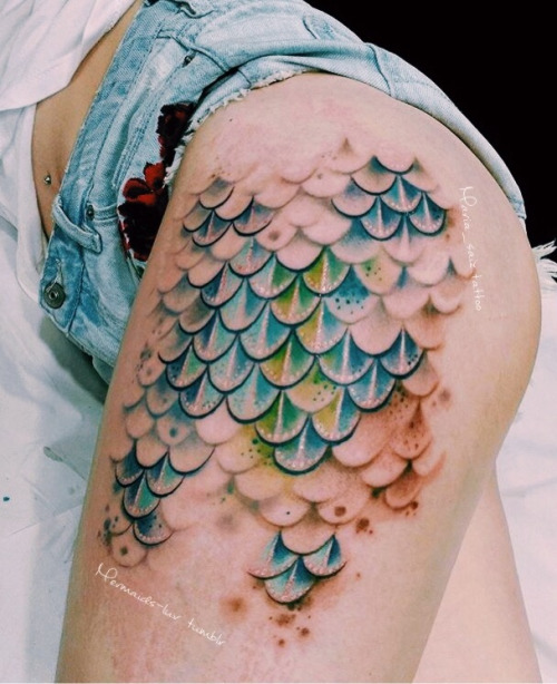 Awesome Colorful Mermaid Scale Tattoo On Girl Left Thigh