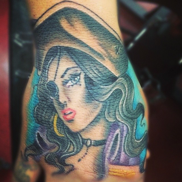 Awesome Colorful Pirate Girl Face Tattoo On Hand