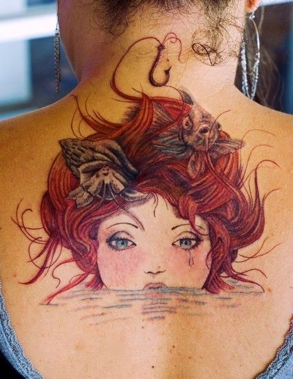 Awesome Swimming Mermaid Head Tattoo On Upper Back