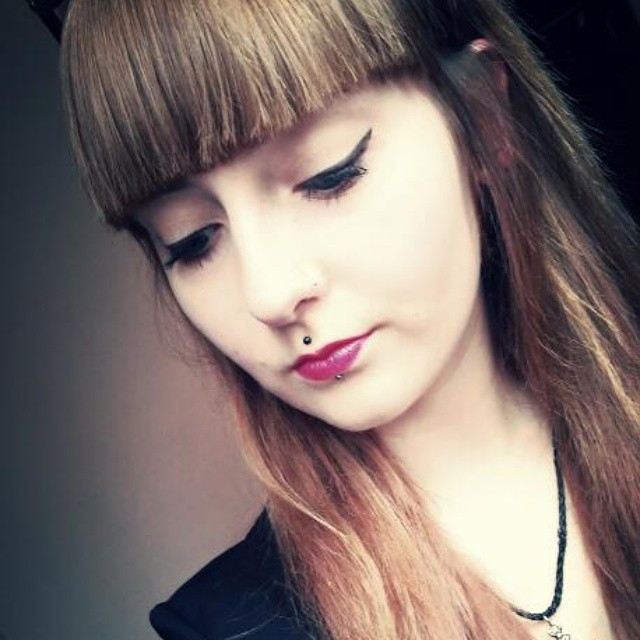 Beautiful Girl Have Lower Lip and Medusa Piercing With Green stud
