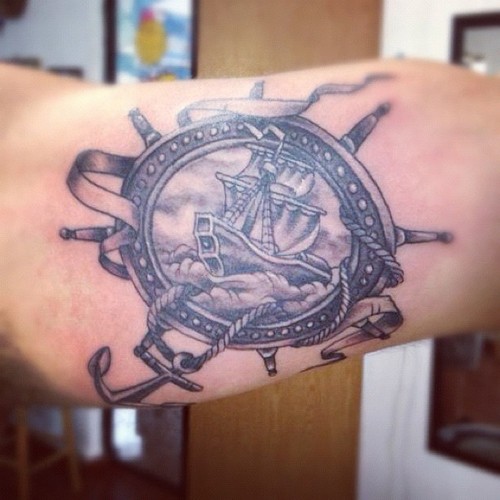 Black And Grey Pirate Ship In Frame With Anchor Tattoo Design For Bicep