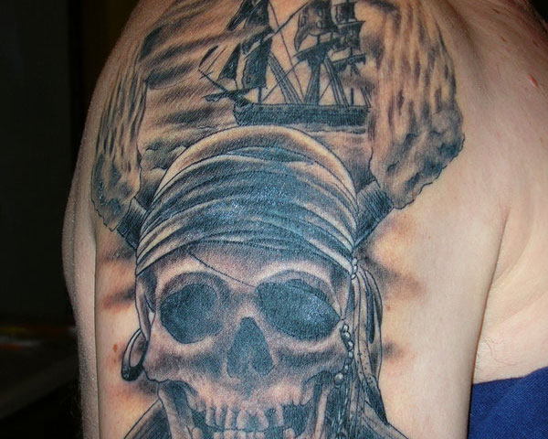 Black And Grey Pirate Skull With Ship Tattoo Design For Shoulder