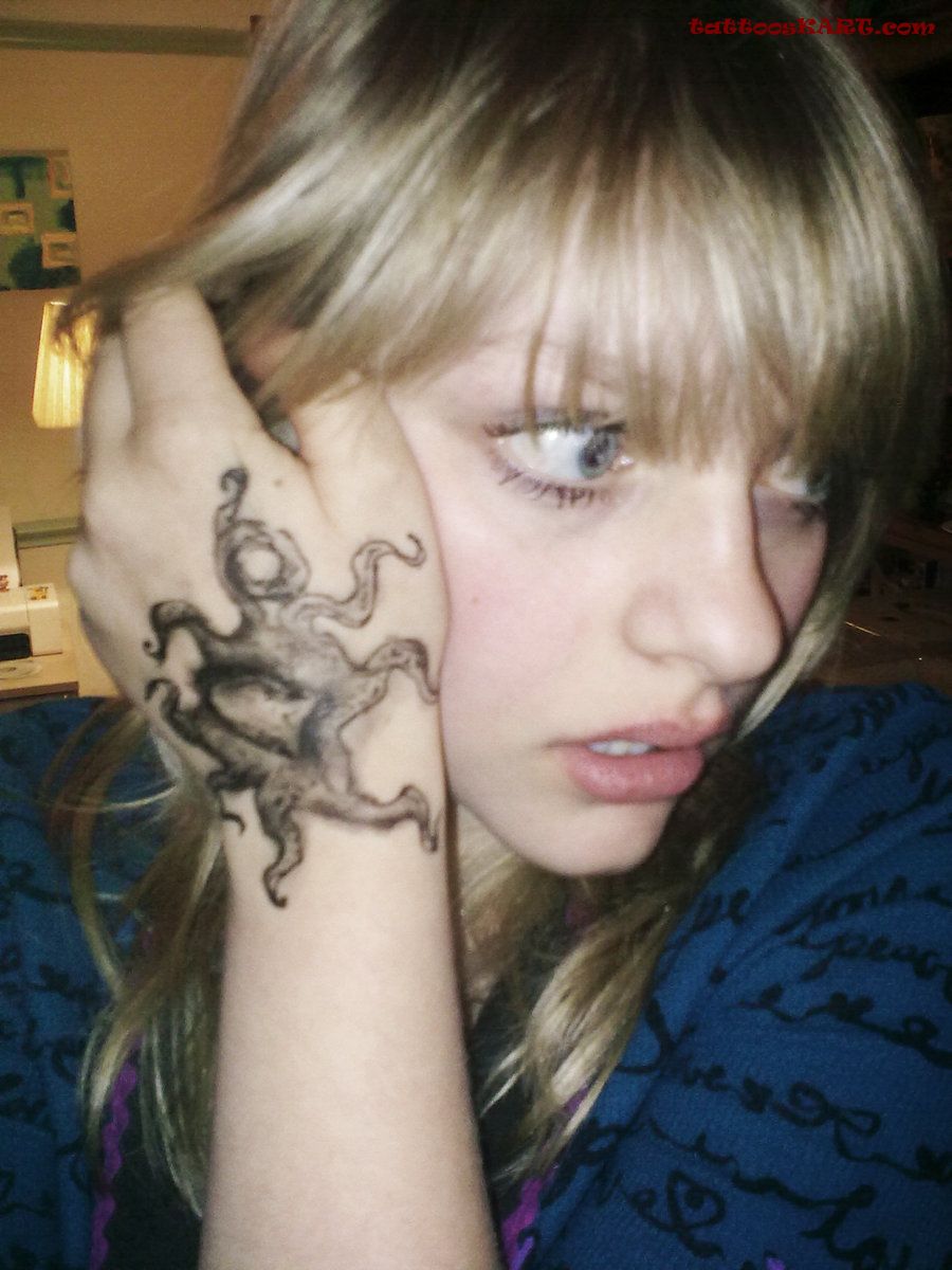 Black And Grey Small Octopus Tattoo On Girl Left Hand
