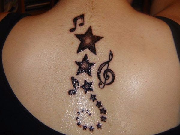 Black And Grey Stars And Music Notes Tattoo On Upper Back