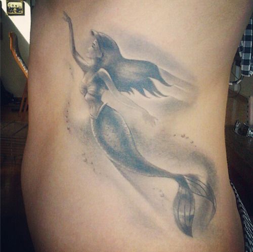 Black And Grey Swimming Mermaid Tattoo On Left Side Rib
