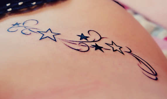 Black And Outline Star Tattoos On Hip