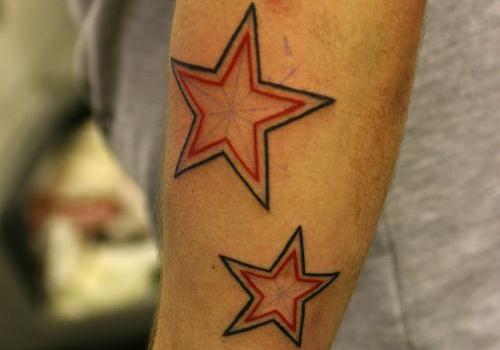 Black And Red Nautical Star Tattoo On Forearm