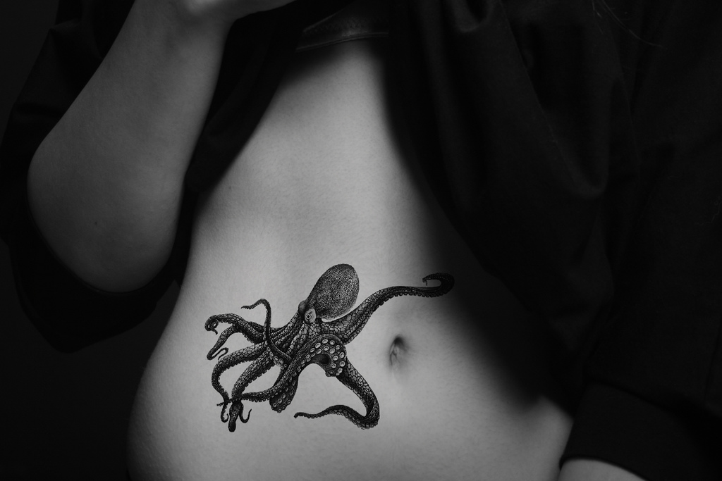 Black And White Octopus Tattoo On Girl Stomach