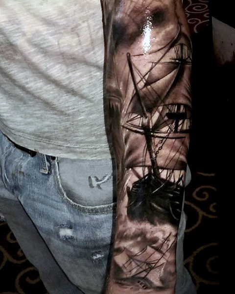 Black Ink Ghost Pirate Ship Tattoo On Left Arm