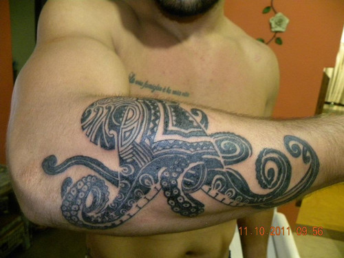 Black Ink Maori Octopus Tattoo On Man Right Arm