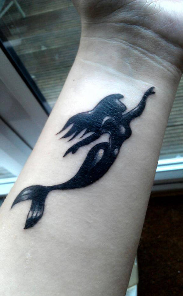 Black Ink Mermaid Tattoo On Girl Left Wrist