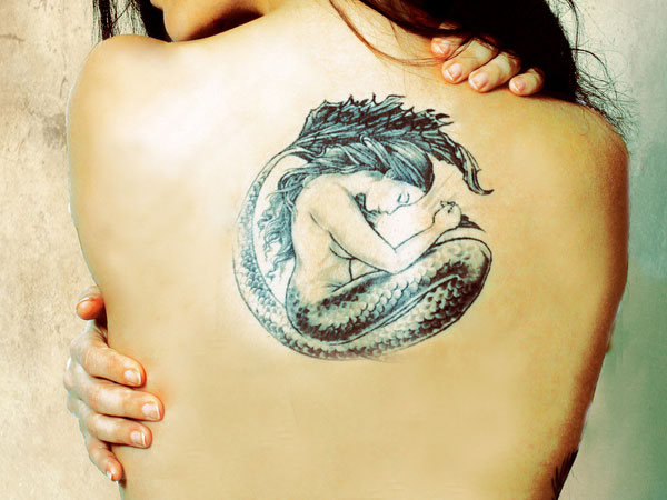 Black Ink Mermaid Tattoo On Girl Upper Back