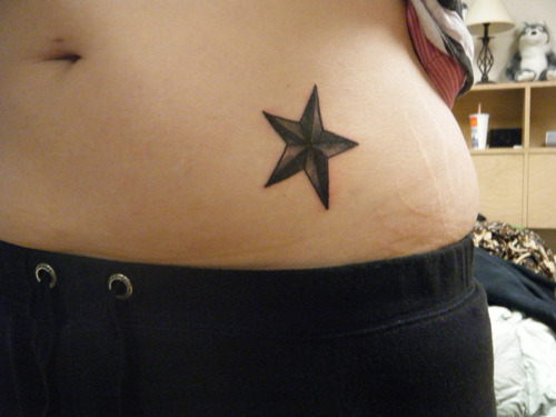 Black Ink Nautical Star Tattoo On Left Hip