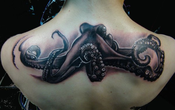 Black Ink Octopus Tattoo On Girl Upper Back
