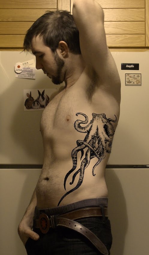 Black Ink Octopus Tattoo On Man Left Side Rib