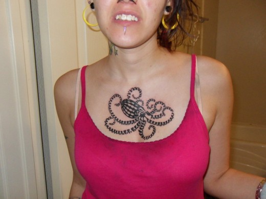Black Ink Octopus Tattoo On Women Left Collarbone