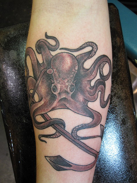 Black Ink Octopus With Anchor Tattoo On Right Forearm