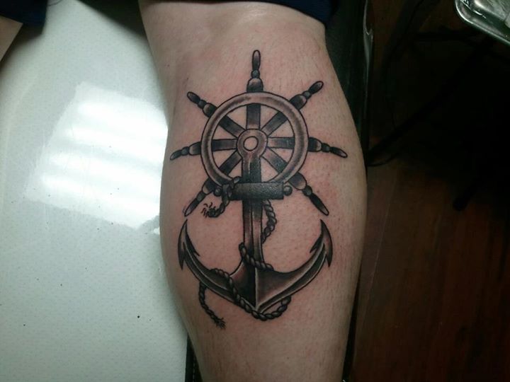 Black Ink Pirate Anchor With Ship Wheel Tattoo Design For Leg Calf