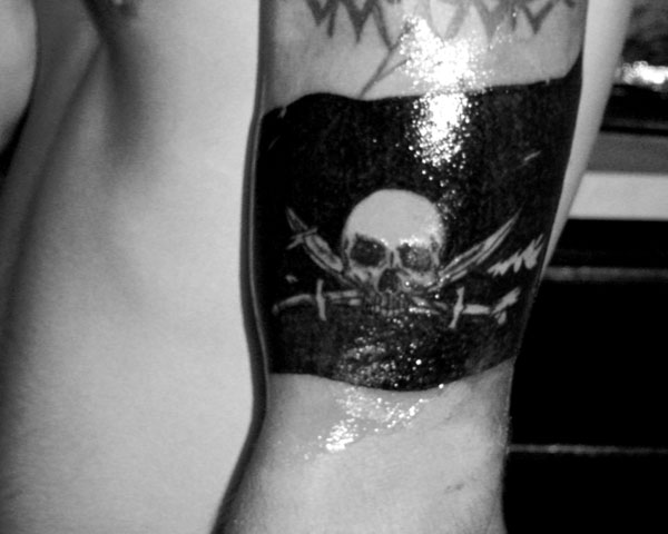 Black Ink Pirate Flag Tattoo On Man Left Half Sleeve