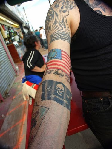 Black Ink Pirate Flag Tattoo On Right Arm