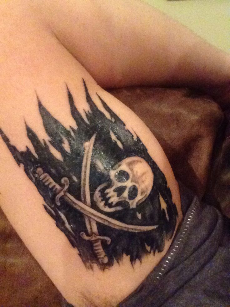 Black Ink Pirate Flag Tattoo On Right Bicep