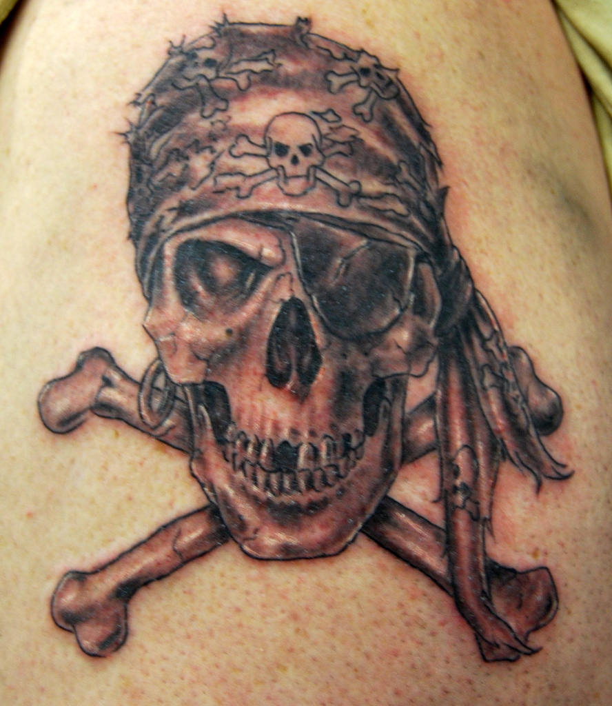 Black Ink Pirate Skull With Two Crossing Bones Tattoo Design For Shoulder