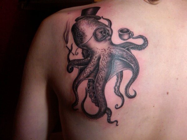 Black Ink Small Gentleman Octopus Tattoo On Left Back Shoulder