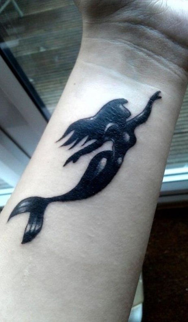 Black Ink Swimming Mermaid Tattoo On Left Wrist
