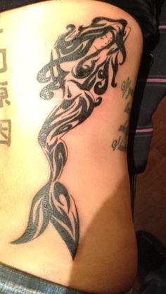 Black Ink Tribal Mermaid Tattoo On Lower Back