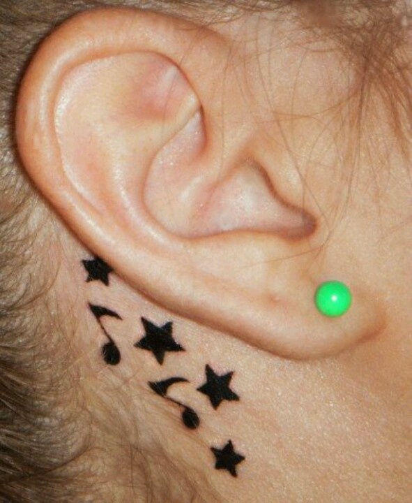 Black Music Notes And Star Tattoos Behind Ear
